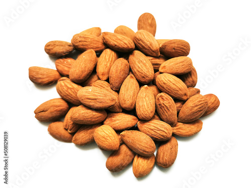 Golden almonds on the white background. Closeup of whole raw almonds