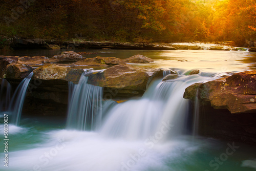 Cascading Arkansas Ozark mountain scene of King River waterfall cascade during a fall sunset