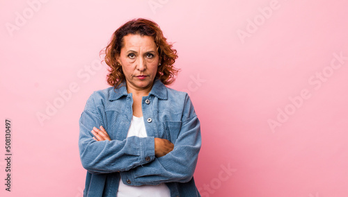 middle age hispanic woman feeling displeased and disappointed, looking serious, annoyed and angry with crossed arms