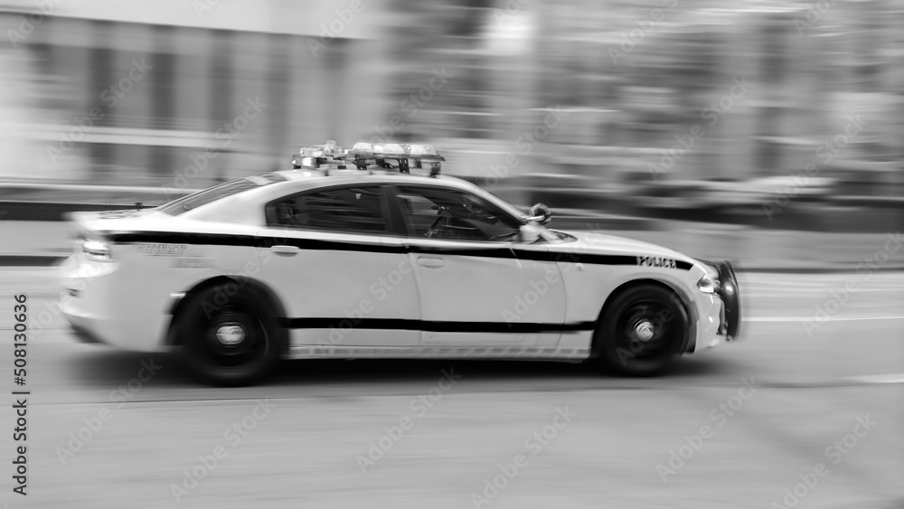 Police car moving fast on city street