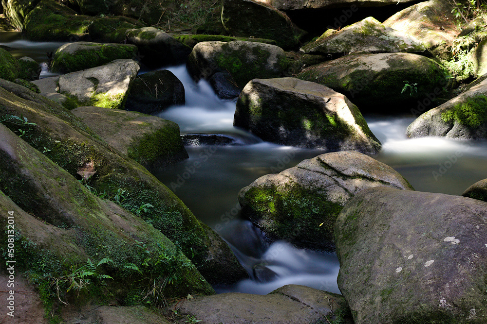 Waterfall photos with a small drop and details of its foam on the rocks Waterfall photos with a small drop and details of its foam on the rocks