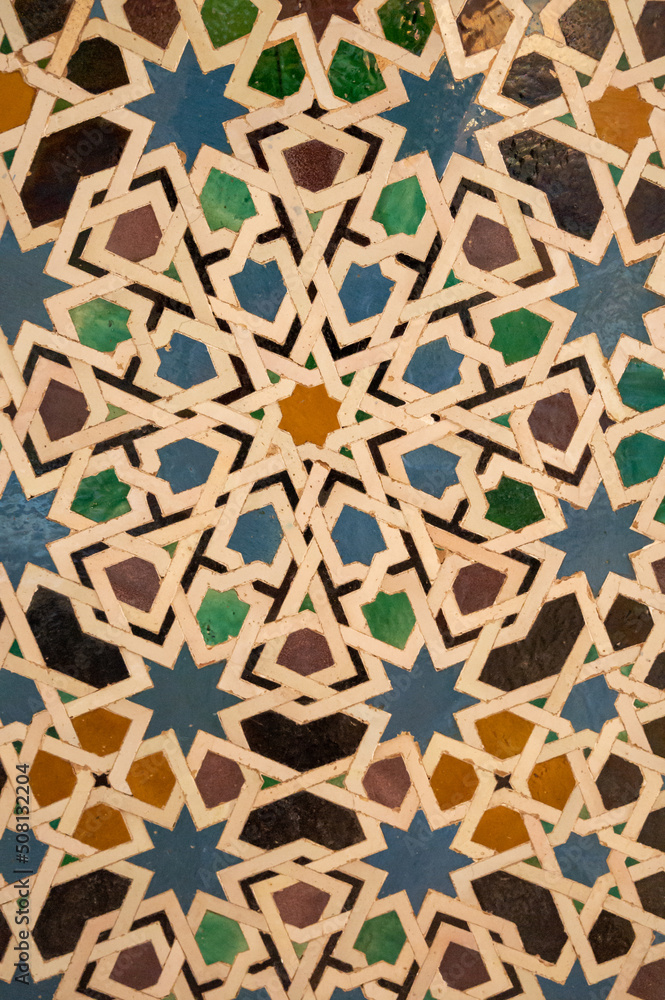 Ornamental medieval ceramic tiles of walls in Nasrid Palaces in the Alhambra palace Granada, Andalusia, Spain Ornamental medieval ceramic tiles of walls in Nasrid Palaces in the Alhambra palace Granada, Andalusia, Spain