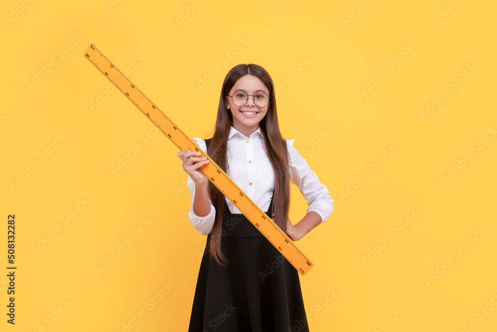 cheerful kid in school uniform and glasses hold mathematics ruler for measuring, geometry cheerful kid in school uniform and glasses hold mathematics ruler for measuring, geometry