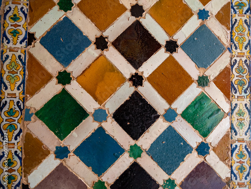 Ornamental medieval ceramic tiles of walls in Nasrid Palaces in the Alhambra palace Granada, Andalusia, Spain