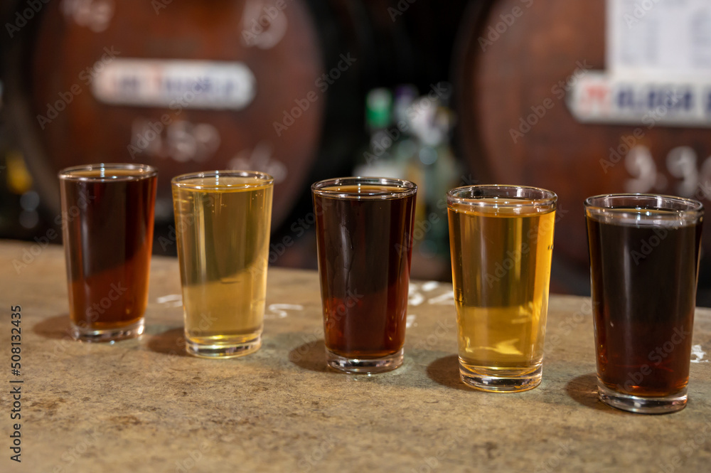 Tasting of different sweet wines from wooden barrels on old bodega in central part of Malaga, Andalusia, Spain Tasting of different sweet wines from wooden barrels on old bodega in central part of Malaga, Andalusia, Spain