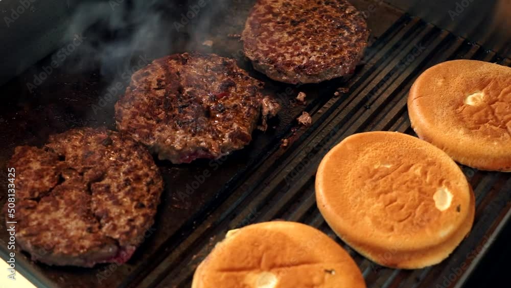 Burger in the making on a grill Burger in the making on a grill