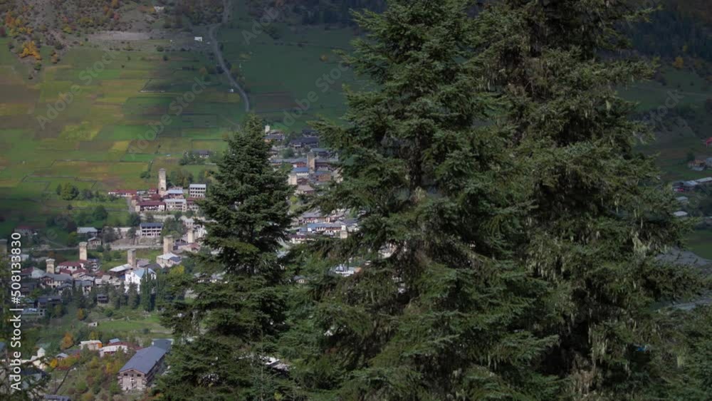 View of a small old mountain village between the pine trees. Dolly shot, slow motion. View of a small old mountain village between the pine trees. Dolly shot, slow motion.