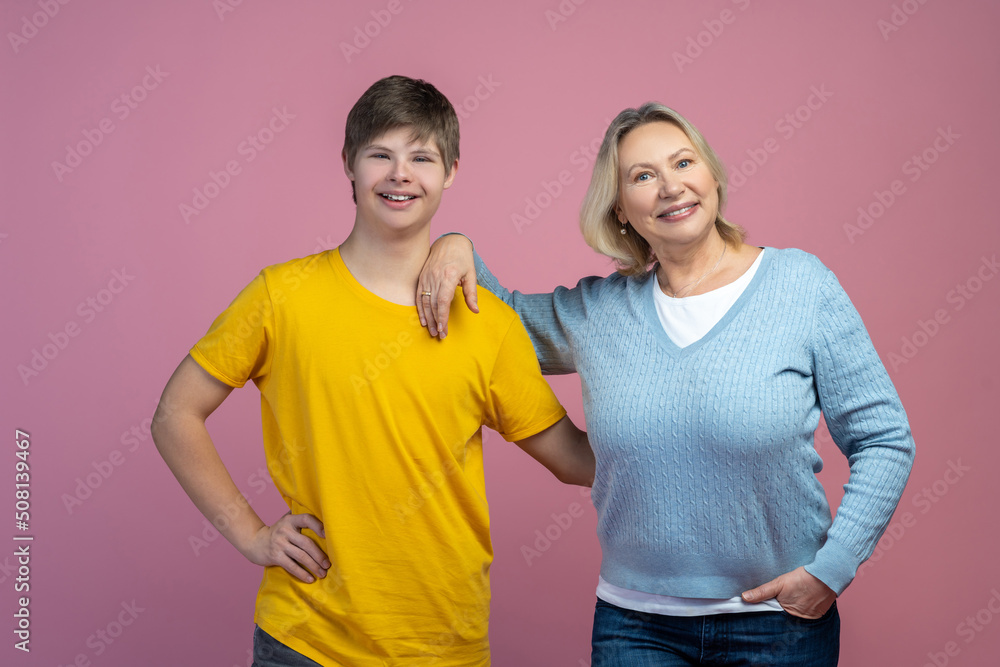 Woman and guy smiling at camera on light background Woman and guy smiling at camera on light background