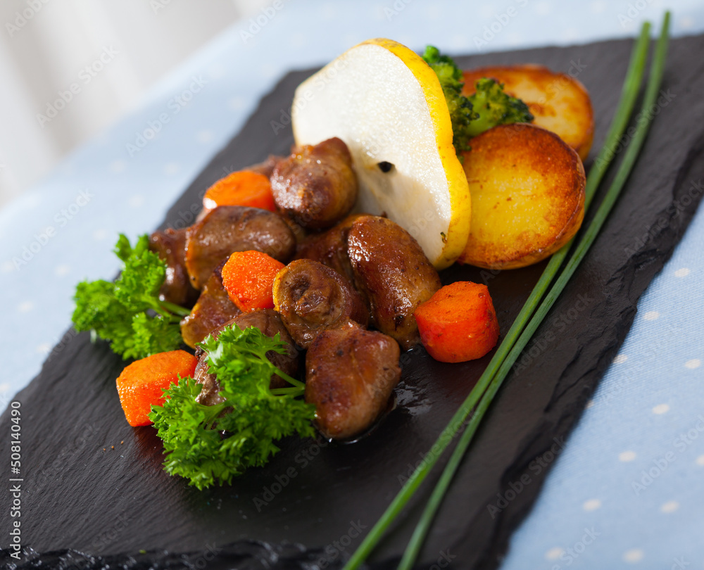 Roasted chicken hearts with baked potatoes, steamed broccoli, carrots and slice of pear