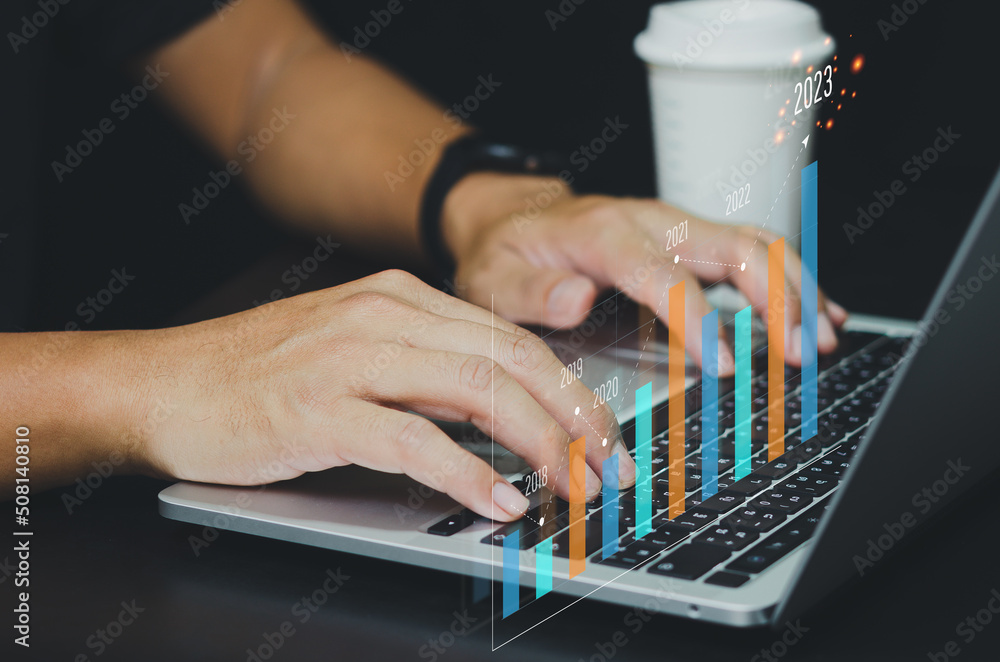 Fototapeta premium Business Analysis, Economic Growth, Finance with Virtual Graphs and Charts 2023.businessman using modern computer technology.
