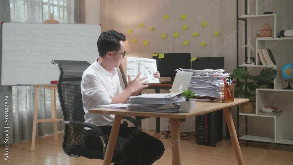 Asian Man With Documents Explaining Work On Paper While Having Video Call On Laptop At The Office
Asian Man With Documents Explaining Work On Paper While Having Video Call On Laptop At The Office