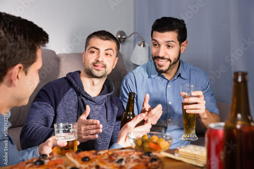 Friendly meeting in men company over beer with pizza. High quality photo