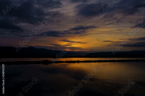 田植え前の水田の水に映り込む山里の夕景 © askaflight