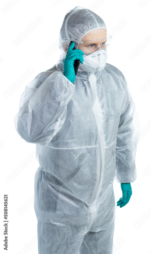a man in special protective clothing is phoning. isolated a man in special protective clothing is phoning. isolated
