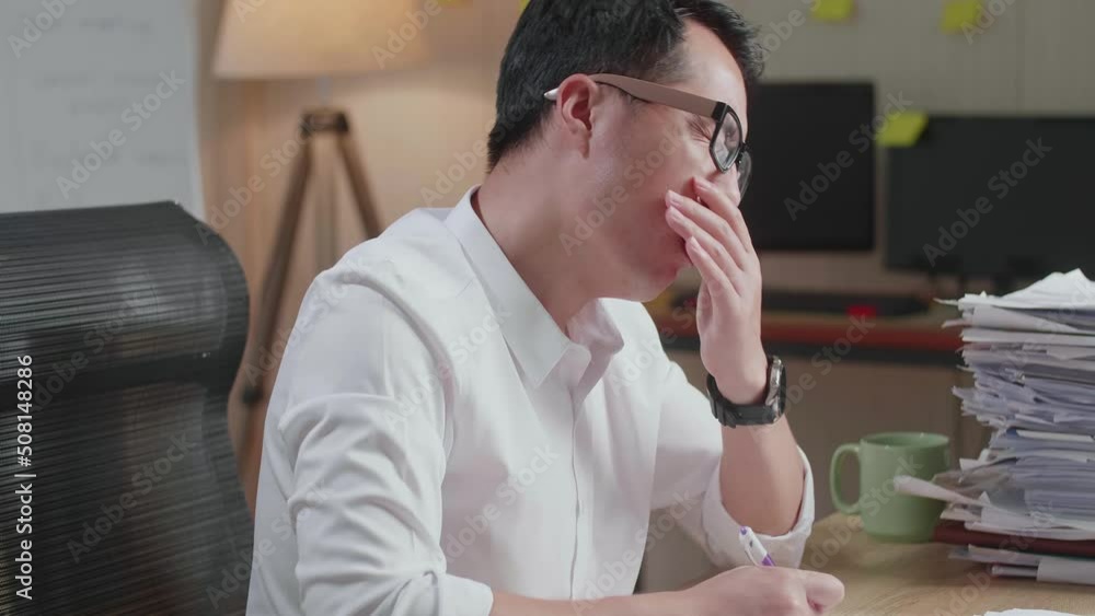 Close Up Of Tired Asian Man Yawning And Taking Off His Glasses Before Sleeping While Working Hard With Documents At The Office
Close Up Of Tired Asian Man Yawning And Taking Off His Glasses Before Sleeping While Working Hard With Documents At The Office