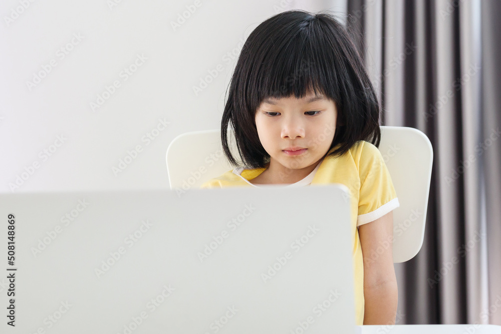 little asian girl student study online using laptop computer at home little asian girl student study online using laptop computer at home