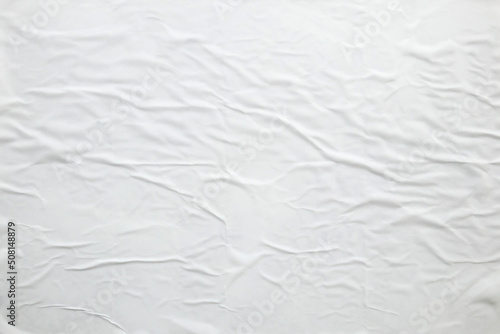 white crumpled and creased paper poster texture background © Kwangmoozaa