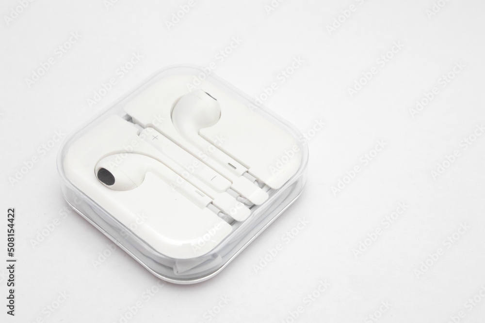 White wired headphones in the case White wired headphones in the case