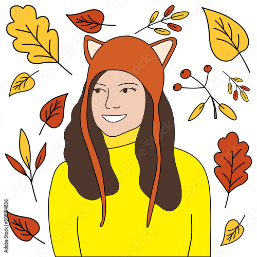 a pretty girl in a hat with ears and a sweater, against the background of autumn leaves.