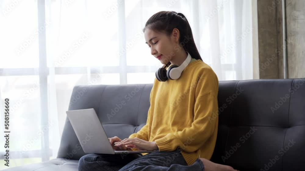 Asian girl student learning online via the internet with tutor on laptop, asian woman happy smile typing work on computer, Concept online learning at home Asian girl student learning online via the internet with tutor on laptop, asian woman happy smile typing work on computer, Concept online learning at home
