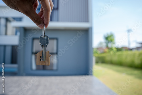 Selling home ,Landlord and New home. The house key for unlocking a new house is plugged into the door. Mortgage, rent, buy, sell, move home concept.