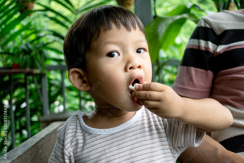 Little boy eating food on resturant.Asian boy. Little boy eating food on resturant.Asian boy.