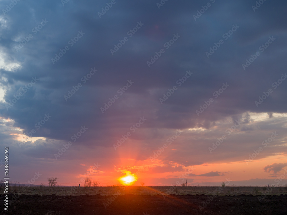 Nature sunset. Beautiful evening sky. The sun sets over the horizon Nature sunset. Beautiful evening sky. The sun sets over the horizon