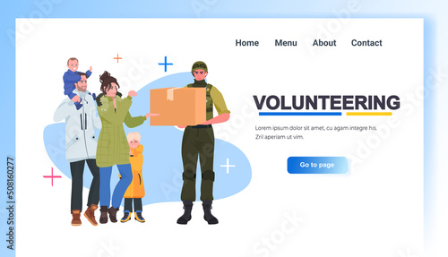 volunteer in military clothes giving help boxes to refugee humanitarian aid material assistance governmental help