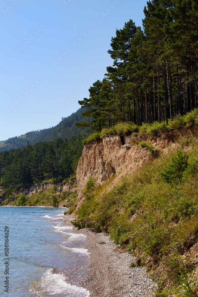 The shore of Lake Baikal on a summer day. Beautiful summer landscape. Vertical orientation