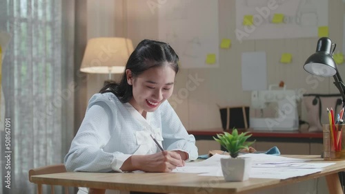 Asian Woman Designer Is Drawing On The Layout Bond At The Office
 photo