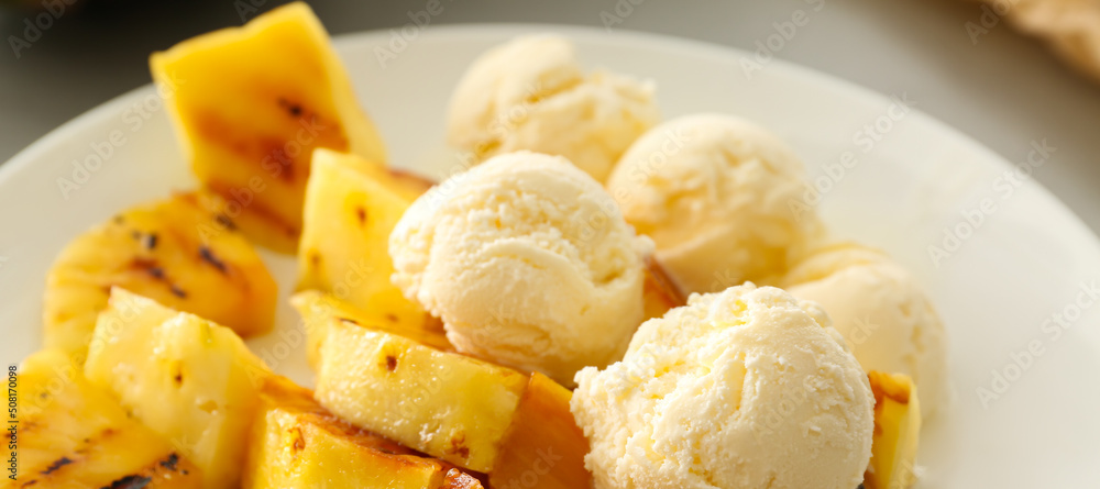 Grilled pineapple slices and ice cream on plate, closeup Grilled pineapple slices and ice cream on plate, closeup