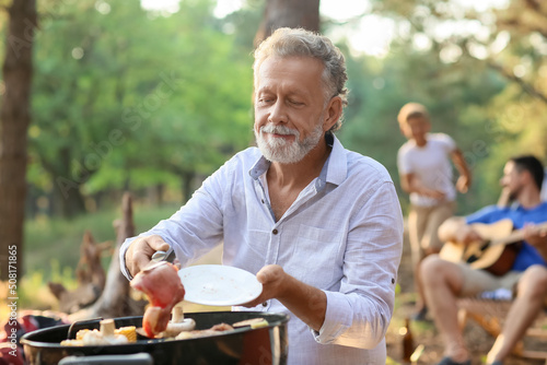 Senior man cooking food on ...