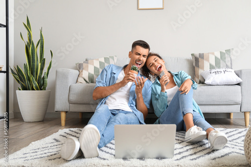 Young couple with laptop si...