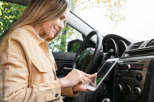 Female driver using tablet ...