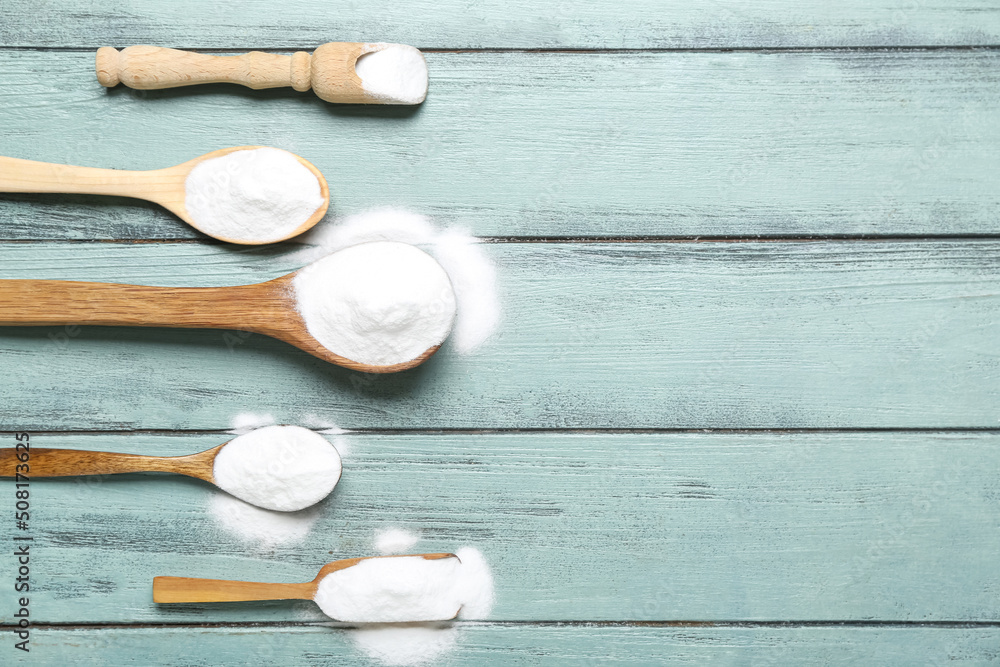 Spoons with baking soda on color wooden background Spoons with baking soda on color wooden background