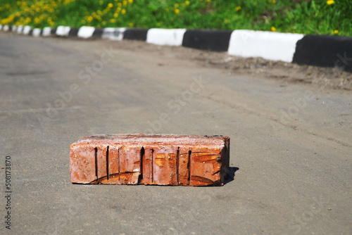 One brick lies on the road. photo