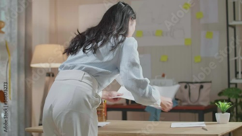 Back View Of A Woman Designer Arranging The Bag Sketching Layout Bond At The Office
 photo