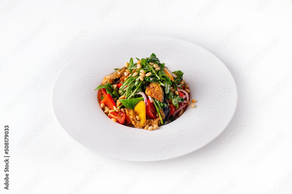 salad with fresh and fried vegetables with nuts and herbs. on a white background