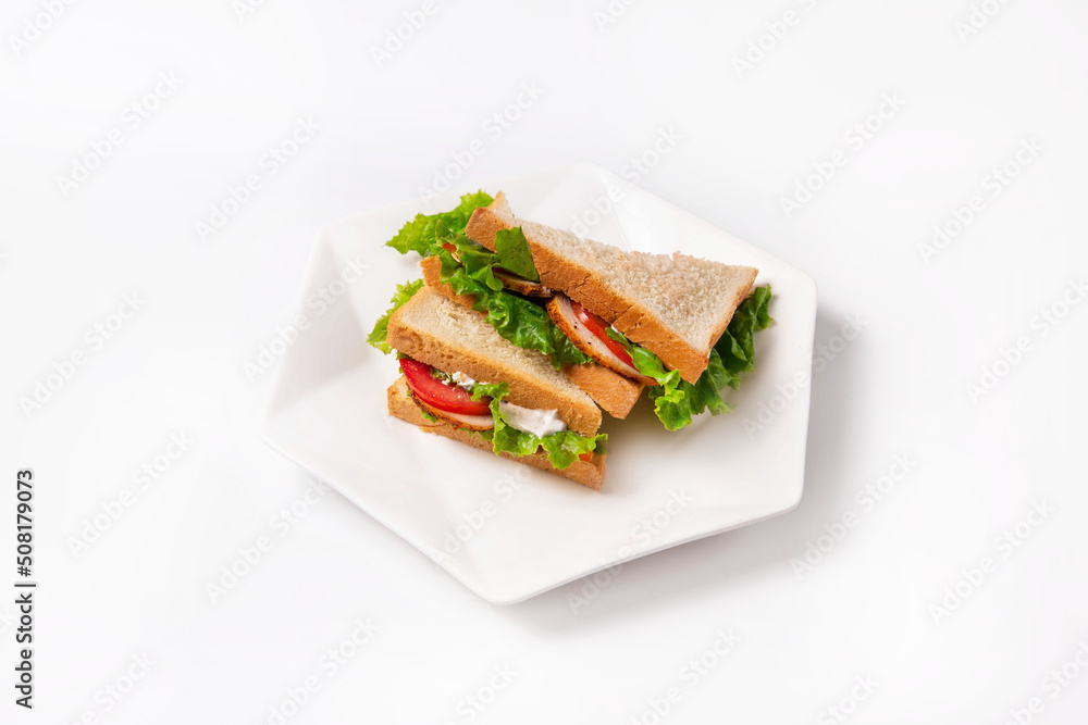 sandwiches with tomatoes, chicken meat, mayonnaise and lettuce leaves. on a white background sandwiches with tomatoes, chicken meat, mayonnaise and lettuce leaves. on a white background