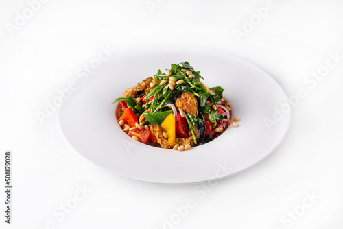 salad with fresh and fried vegetables with nuts and herbs. on a white background