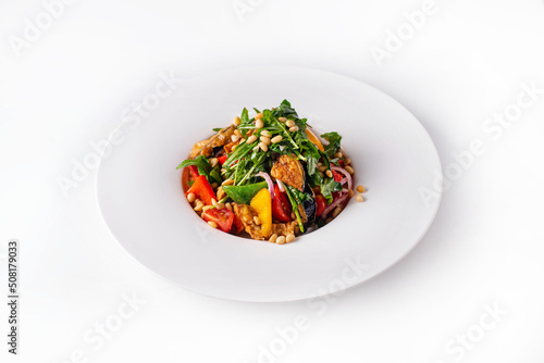 salad with fresh and fried vegetables with nuts and herbs. on a white background