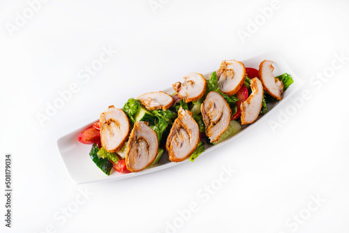 salad of chopped chicken meat with fresh vegetables. on a white background