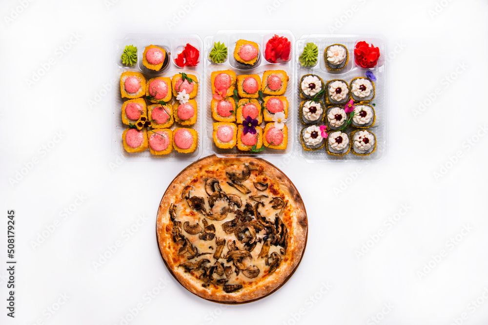set. pizza with Japanese rolls, dried fruits in plastic containers. on a white background set. pizza with Japanese rolls, dried fruits in plastic containers. on a white background