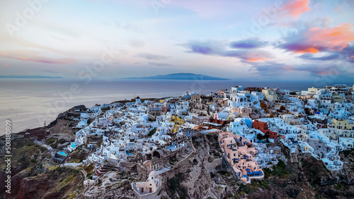 Aerial view with sunset view point of the landmark view in Oia, Santorini. Image of famous village Oia located at one of Cyclades island of Santorini, South Aegean, Greece. © SASITHORN