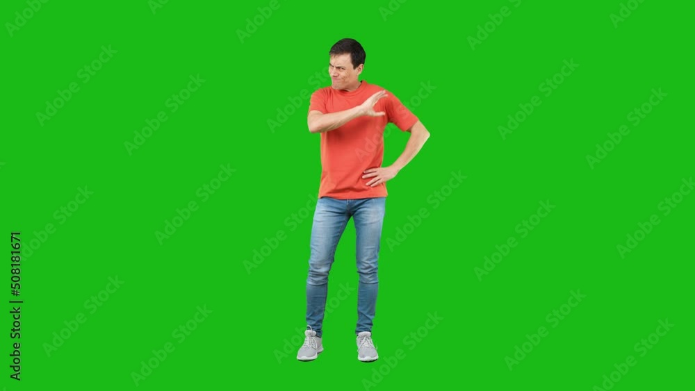 Irritate frowning male standing with hands on waist in studio Irritate frowning male standing with hands on waist in studio