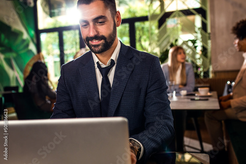 Young businessman working at cafe using laptop. © Zoran Zeremski