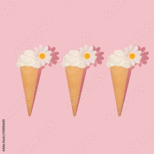 Summer creative pattern with ice cream cones and white flowers on pastel pink background. 70s, 80s or 90s retro aesthetic fashion idea. Minimal summer idea.