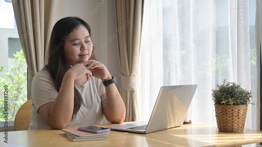 Happy young woman using computer laptop, surfing internet, reading news, shopping online at home Happy young woman using computer laptop, surfing internet, reading news, shopping online at home