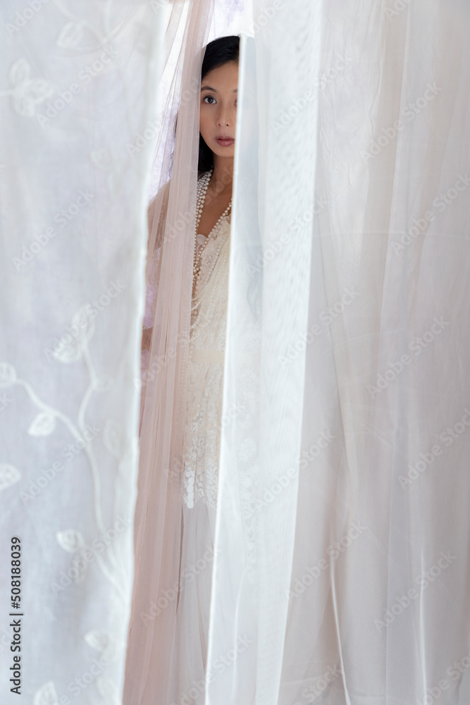 Beautiful Asian woman with long hair wearing a white lace dress and ...