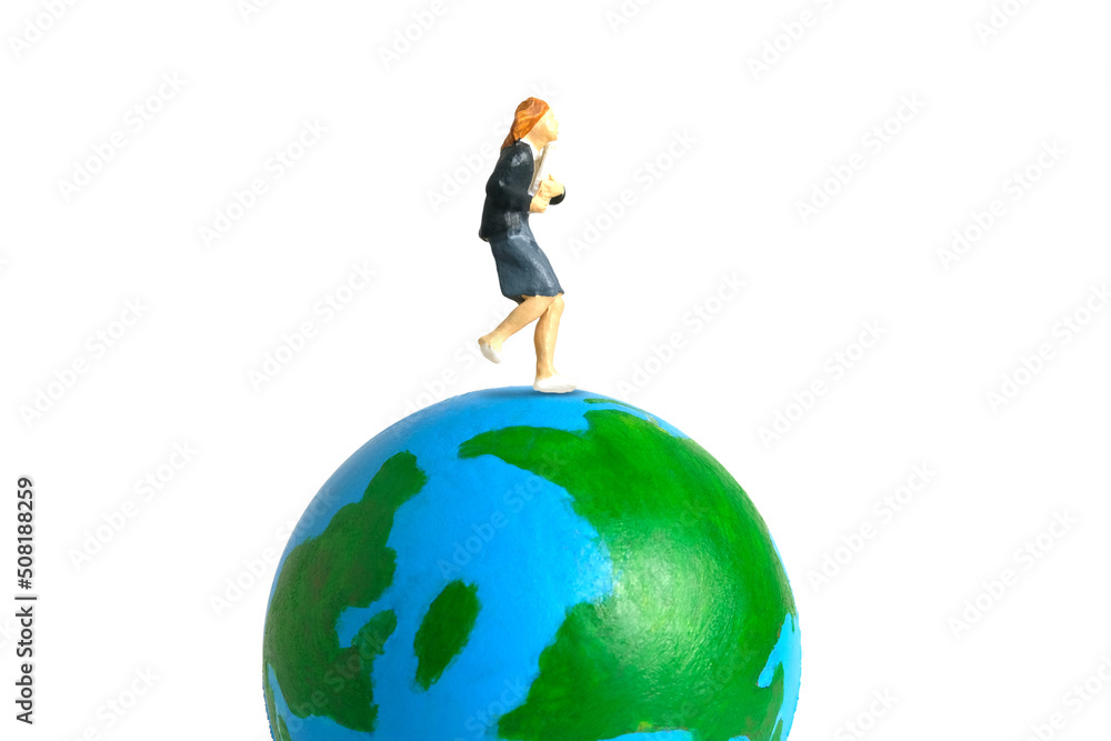 Miniature people toy figure photography. Study abroad and educational ceremony concept. A Young girl pupil running above earth globe isolated on white background Miniature people toy figure photography. Study abroad and educational ceremony concept. A Young girl pupil running above earth globe isolated on white background